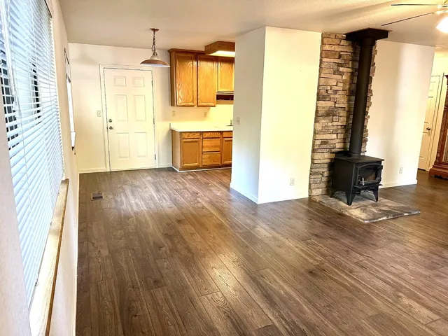 wooden floor in an empty room with a window