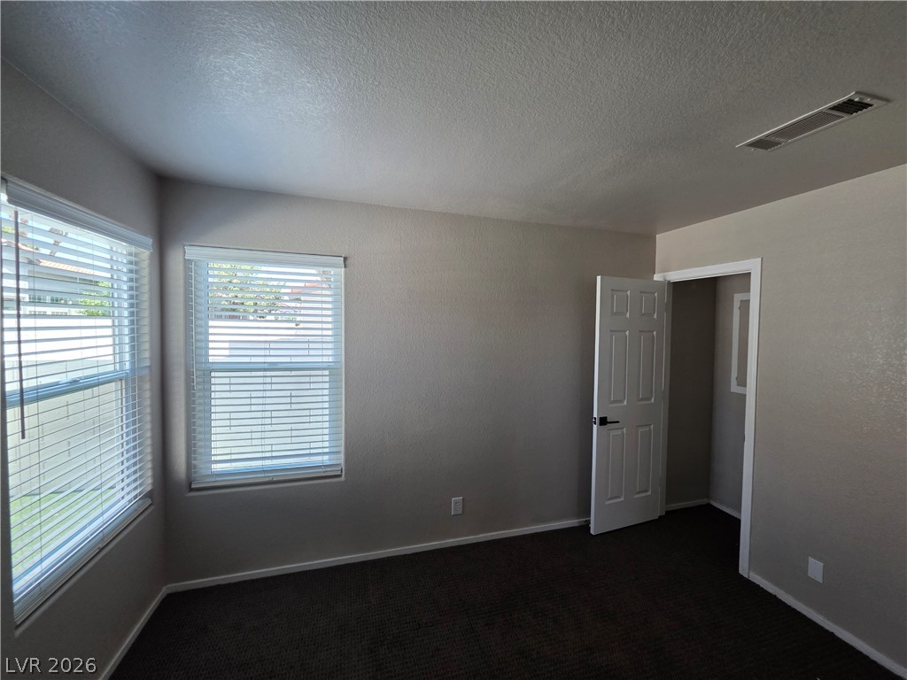 2275 Ramsgate Drive Henderson, NV 89074 - Photo 72 of 84 Well-lit and functional bedroom with multiple windows, providing a comfortable and private retreat.
