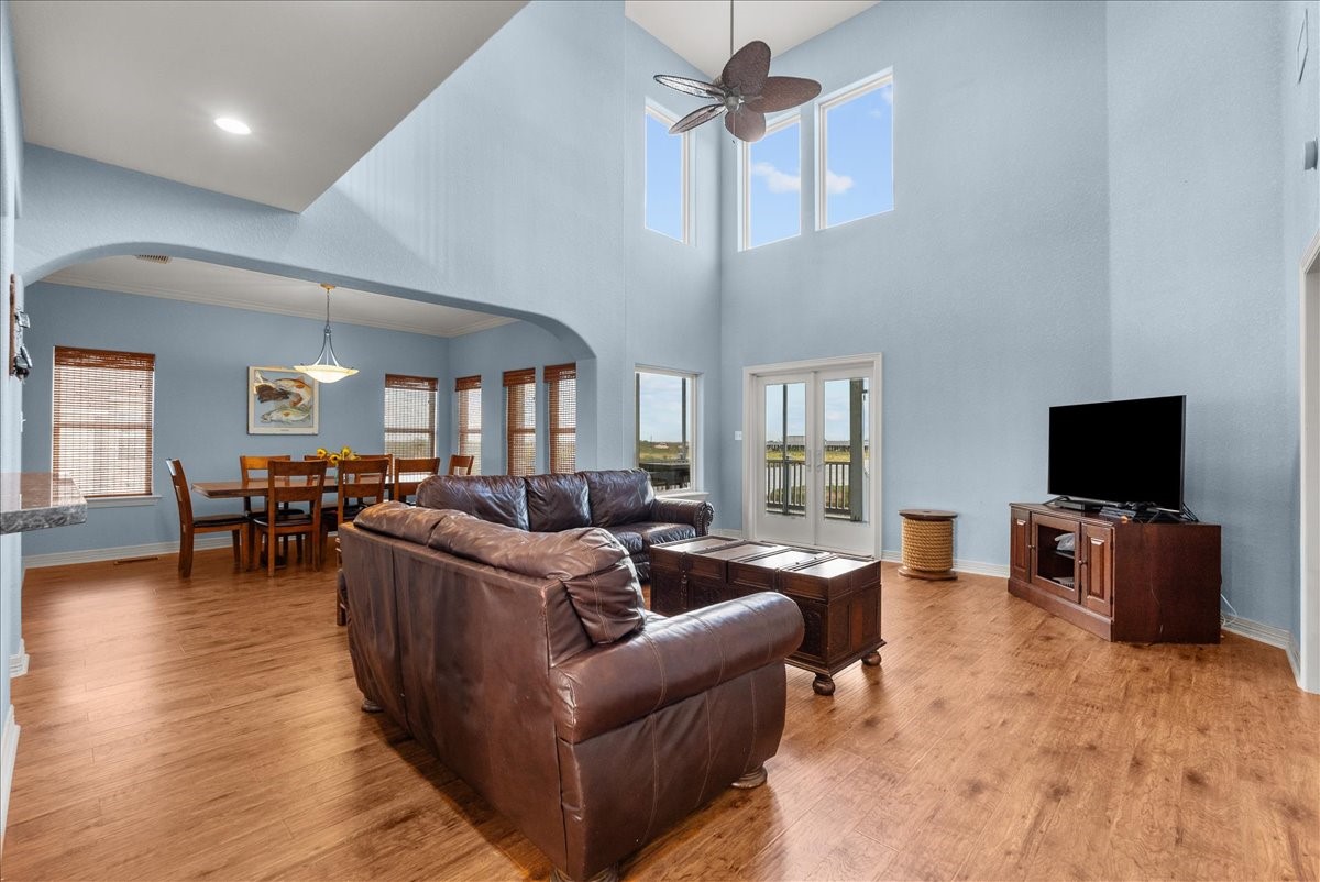 211 Tuna Run Freeport, TX 77541 - Photo 16 of 48 This spacious living area features high ceilings, abundant natural light from large windows, and access to back deck through double doors.