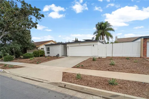 a view of a backyard with a garden and patio