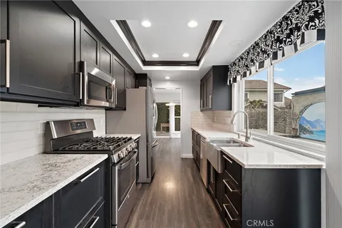 a kitchen with stainless steel appliances granite countertop a stove and a sink