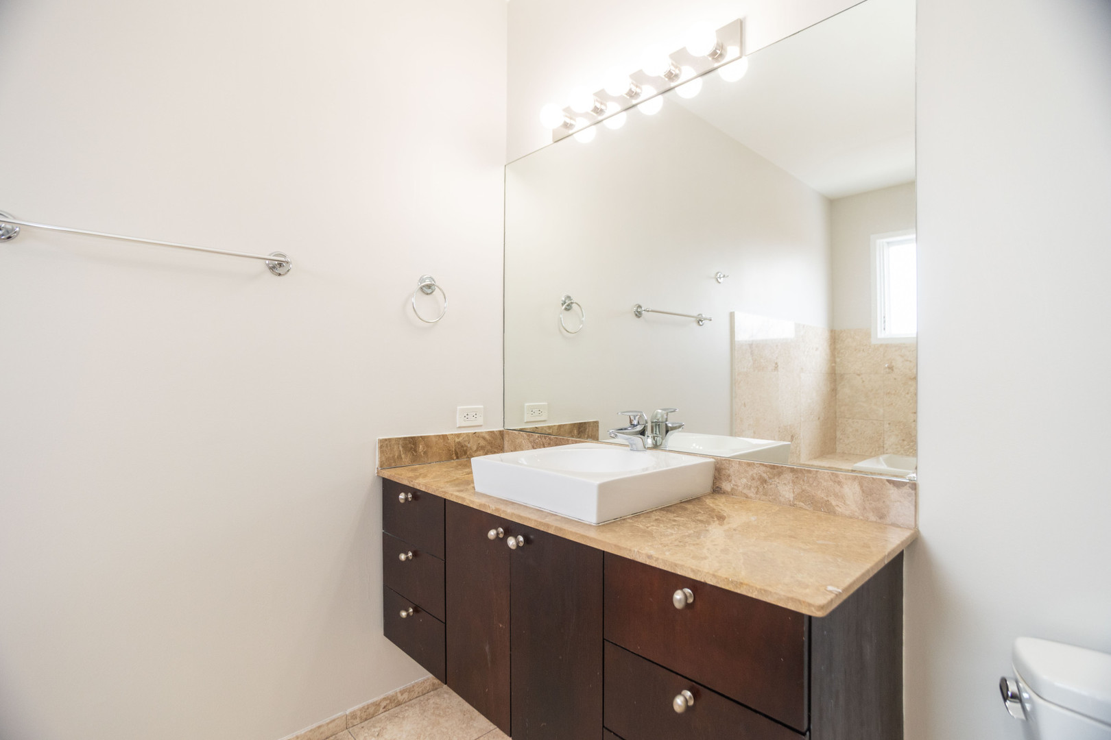 2444 West Madison Street, Unit 3 Chicago, IL 60612 - Photo 12 of 14 a bathroom with a granite countertop sink and a mirror
