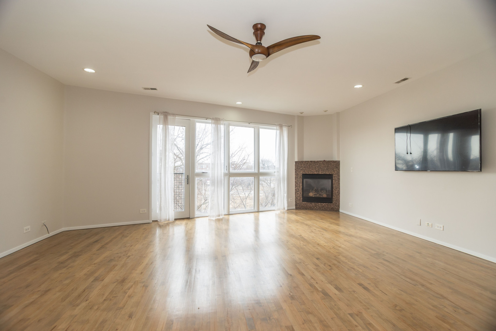 2444 West Madison Street, Unit 3 Chicago, IL 60612 - Photo 2 of 14 a view of empty room with wooden floor and fan