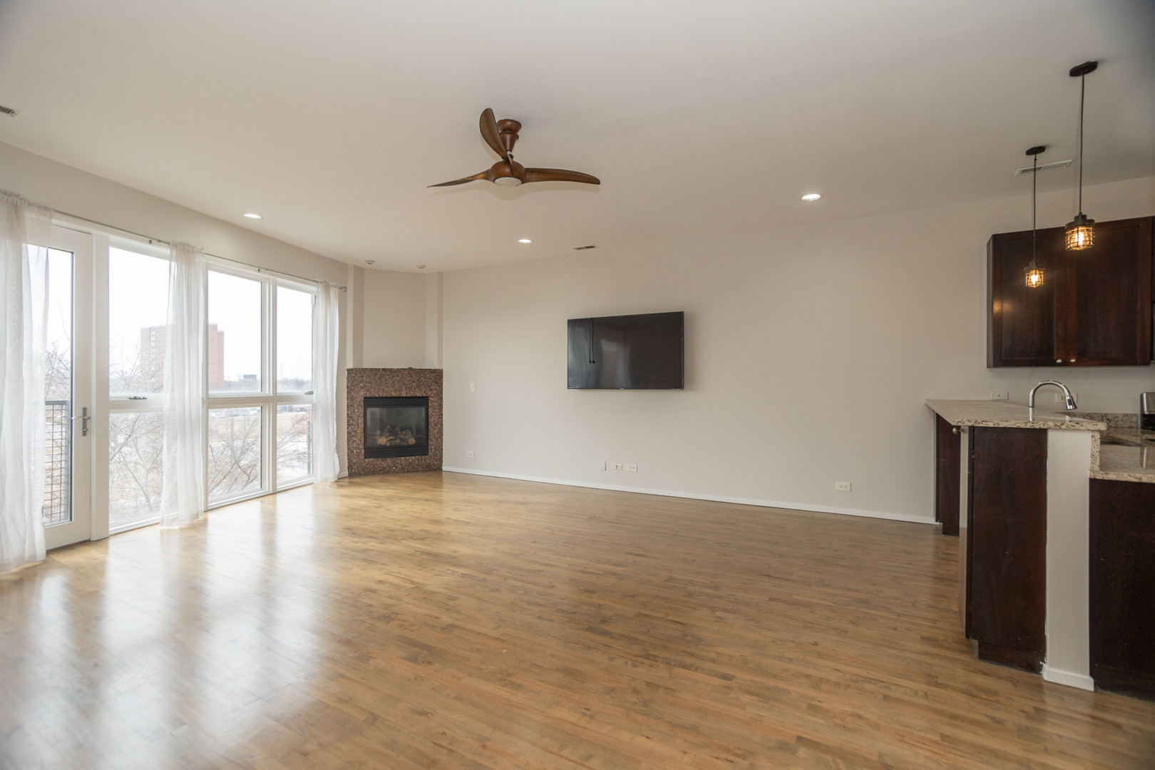 2444 West Madison Street, Unit 3 Chicago, IL 60612 - Photo 3 of 14 a view of an empty room with wooden floor and a window