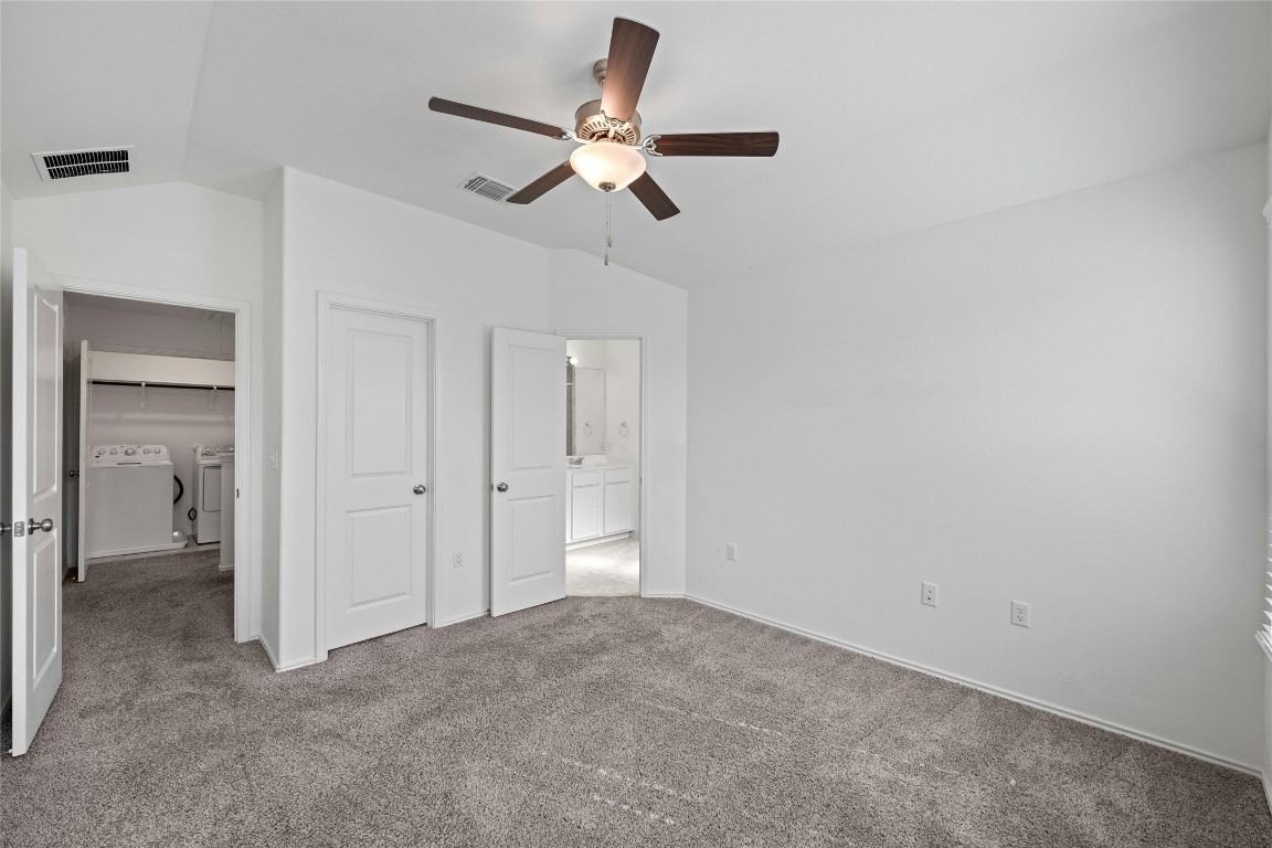 15216 Spruce Frost Cove, Unit B Del Valle, TX 78617 - Photo 11 of 21 a view of an empty room and cabinet with a fan