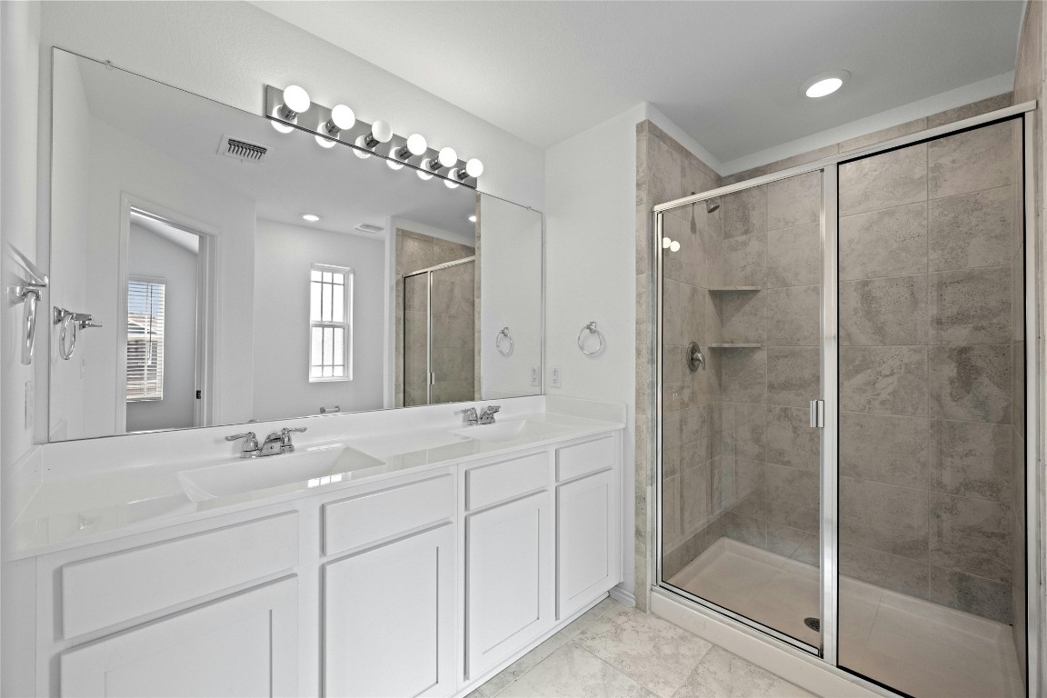 15216 Spruce Frost Cove, Unit B Del Valle, TX 78617 - Photo 12 of 21 a bathroom with a shower sink and mirror