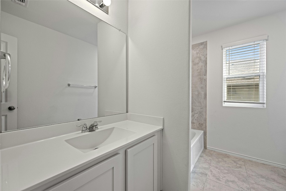 15216 Spruce Frost Cove, Unit B Del Valle, TX 78617 - Photo 15 of 21 a bathroom with a sink and a mirror