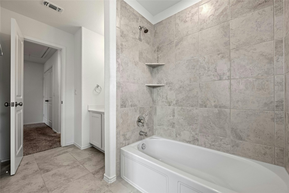 15216 Spruce Frost Cove, Unit B Del Valle, TX 78617 - Photo 16 of 21 a bathroom with a bathtub and a shower