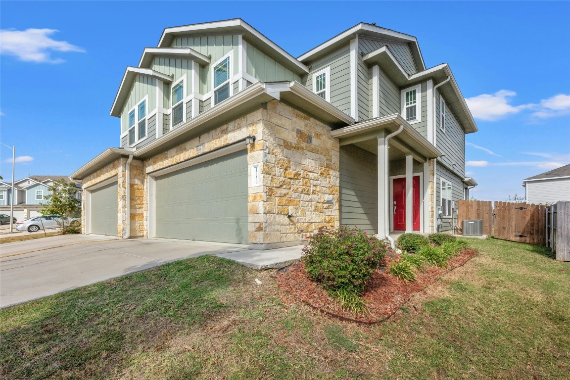 15216 Spruce Frost Cove, Unit B Del Valle, TX 78617 - Photo 2 of 21 a front view of a house with garden