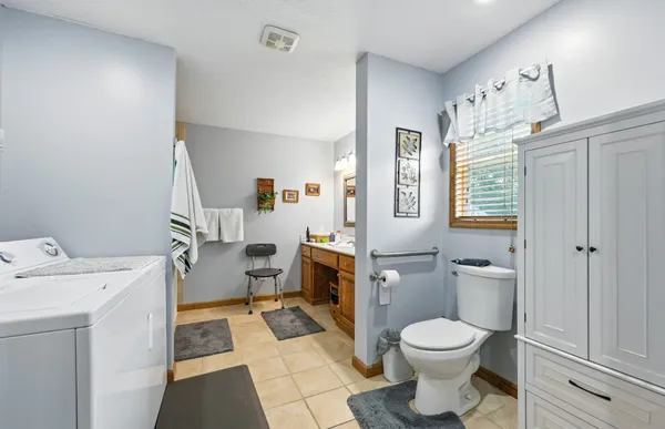 a bathroom with a toilet sink and mirror