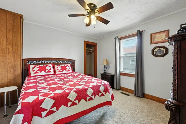 a bedroom with a bed and a chandelier