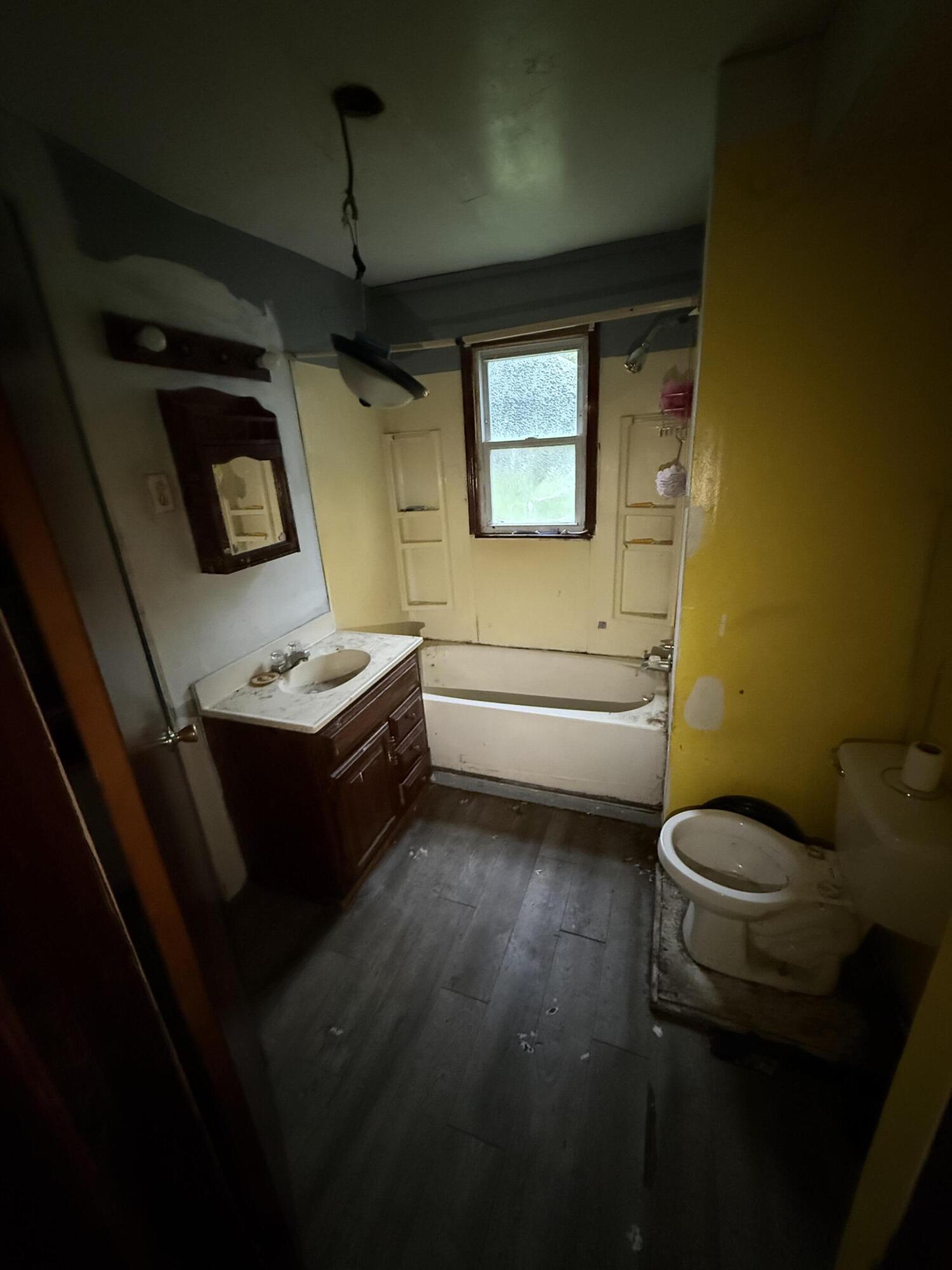 2415 Hanley Street Gary, IN 46406 - Photo 8 of 16 a bathroom with a sink a toilet and mirror
