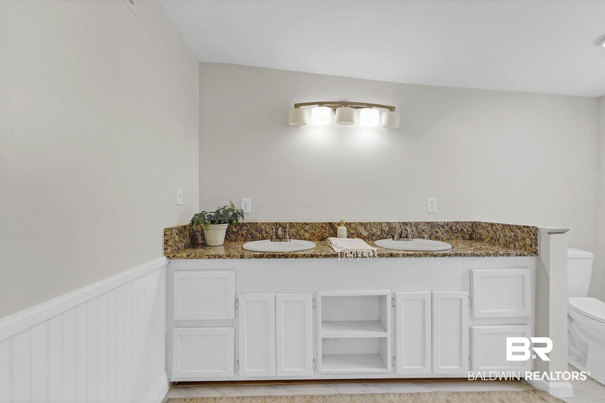 11964 Stroh Road Daphne, AL 36527 - Photo 40 of 58 Full bath featuring toilet, double vanity, a sink, and a wainscoted wall