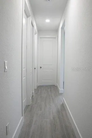 a view of a room with wooden floor