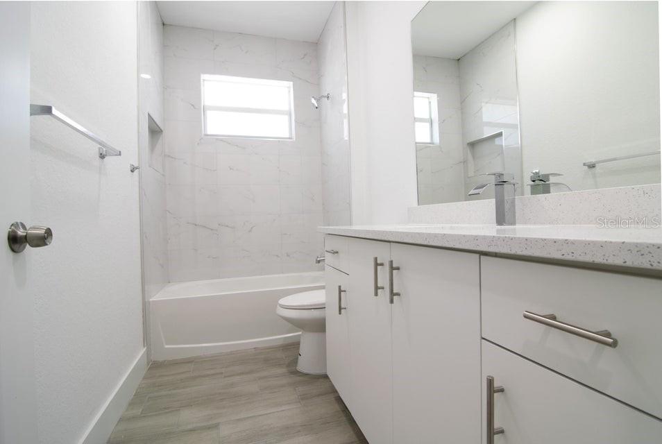 10654 Washington Road Port Charlotte, FL 33981 - Photo 14 of 35 a bathroom with a sink a toilet and a bathtub