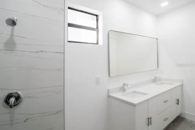 a bathroom with a sink vanity and a mirror