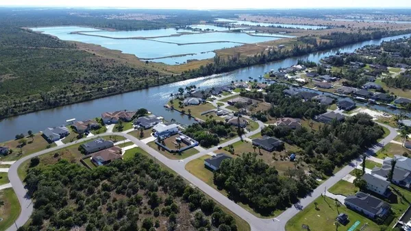 an aerial view of a house with a garden and lake view