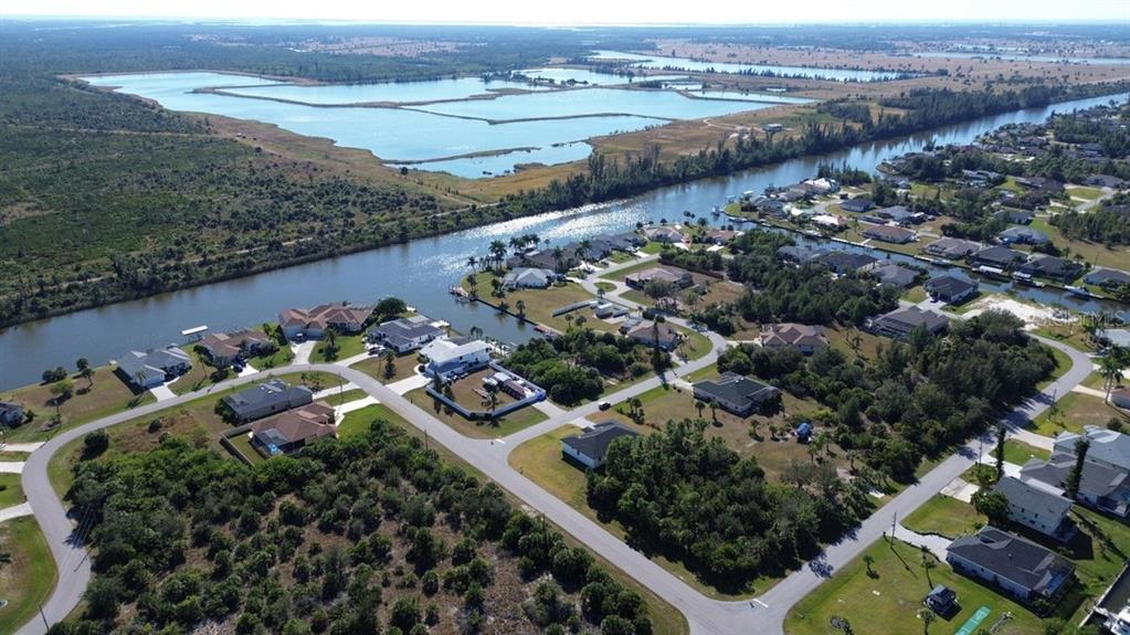 10654 Washington Road Port Charlotte, FL 33981 - Photo 30 of 35 an aerial view of a house with a garden and lake view