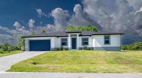 a view of a house with a yard and plants