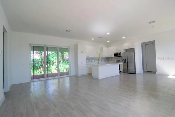 a view of kitchen with wooden floor and windows