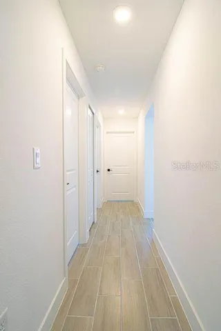a view of a room with wooden floor