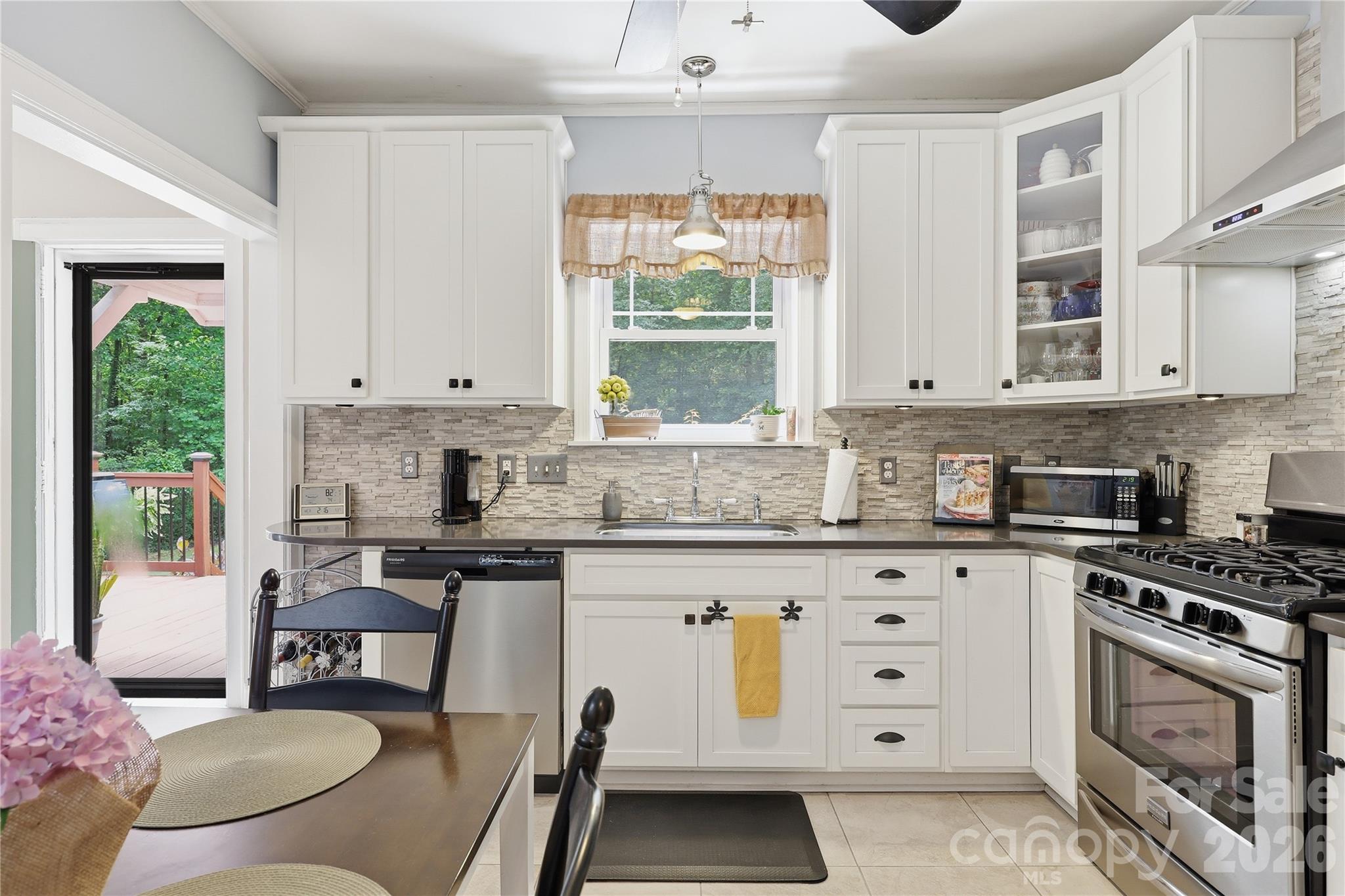 106 Maple Street Fort Mill, SC 29715 - Photo 8 of 44 a kitchen with granite countertop a stove a sink and a microwave