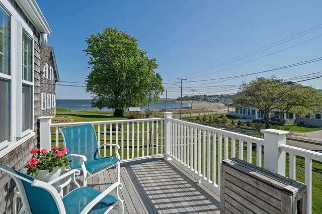 a view of a chair and tables in the balcony