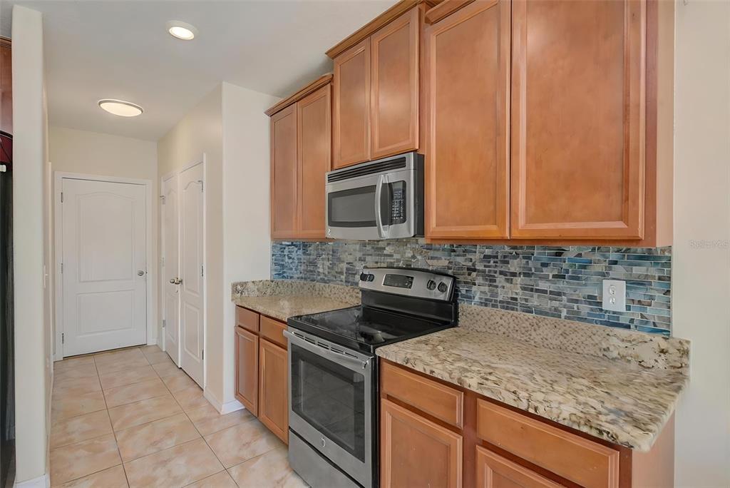 1902 Hawks View Drive Ruskin, FL 33570 - Photo 11 of 41 a kitchen with granite countertop cabinets stainless steel appliances and a sink