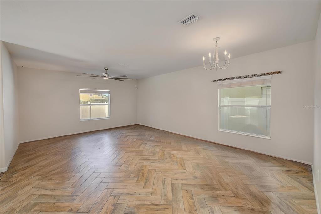 1902 Hawks View Drive Ruskin, FL 33570 - Photo 15 of 41 an empty room with wooden floor and windows