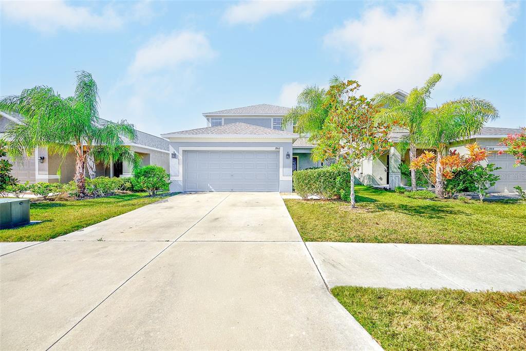 1902 Hawks View Drive Ruskin, FL 33570 - Photo 2 of 41 a front view of a house with a yard and garage