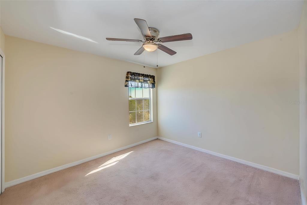 1902 Hawks View Drive Ruskin, FL 33570 - Photo 25 of 41 an empty room with a window and a fan