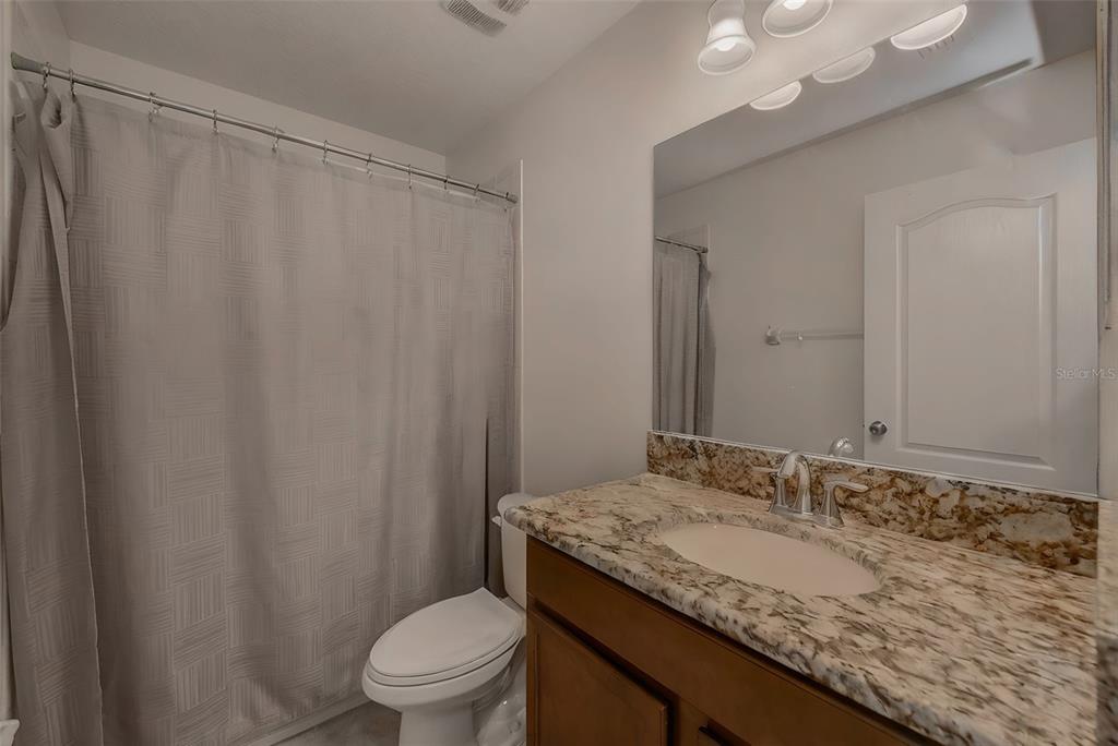 1902 Hawks View Drive Ruskin, FL 33570 - Photo 26 of 41 a bathroom with a granite countertop sink and a mirror