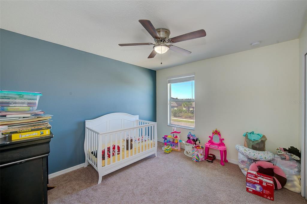 1902 Hawks View Drive Ruskin, FL 33570 - Photo 27 of 41 a view of a room that has a bed and a window in it