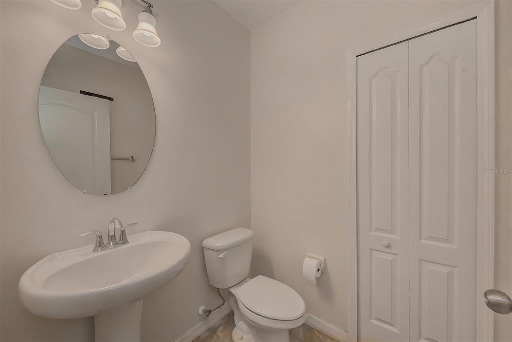 1902 Hawks View Drive Ruskin, FL 33570 - Photo 6 of 41 a bathroom with a toilet a sink and a mirror