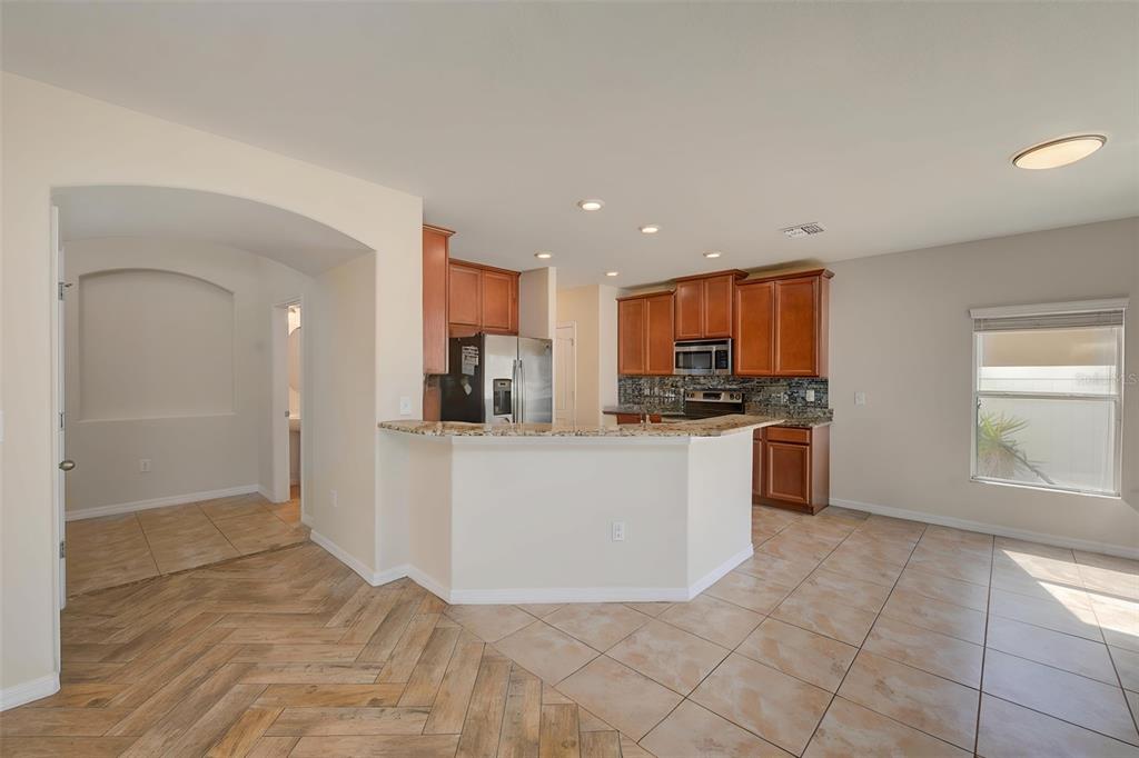 1902 Hawks View Drive Ruskin, FL 33570 - Photo 7 of 41 a large white kitchen with kitchen island granite countertop a large counter top and stainless steel appliances