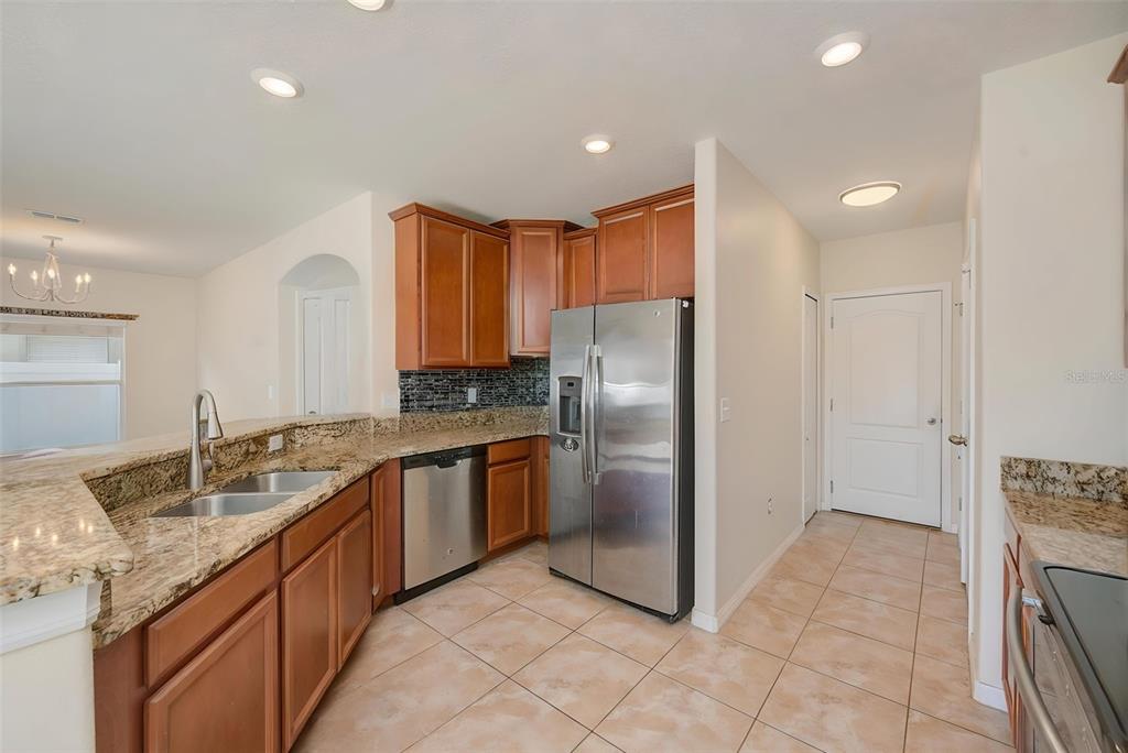 1902 Hawks View Drive Ruskin, FL 33570 - Photo 9 of 41 a kitchen with stainless steel appliances granite countertop a sink and a refrigerator