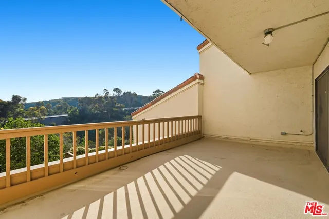 a view of balcony with wooden floor