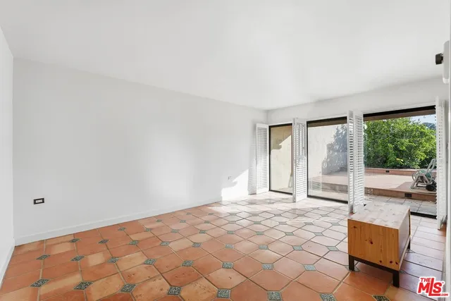 a view of a room with a sink and a mirror
