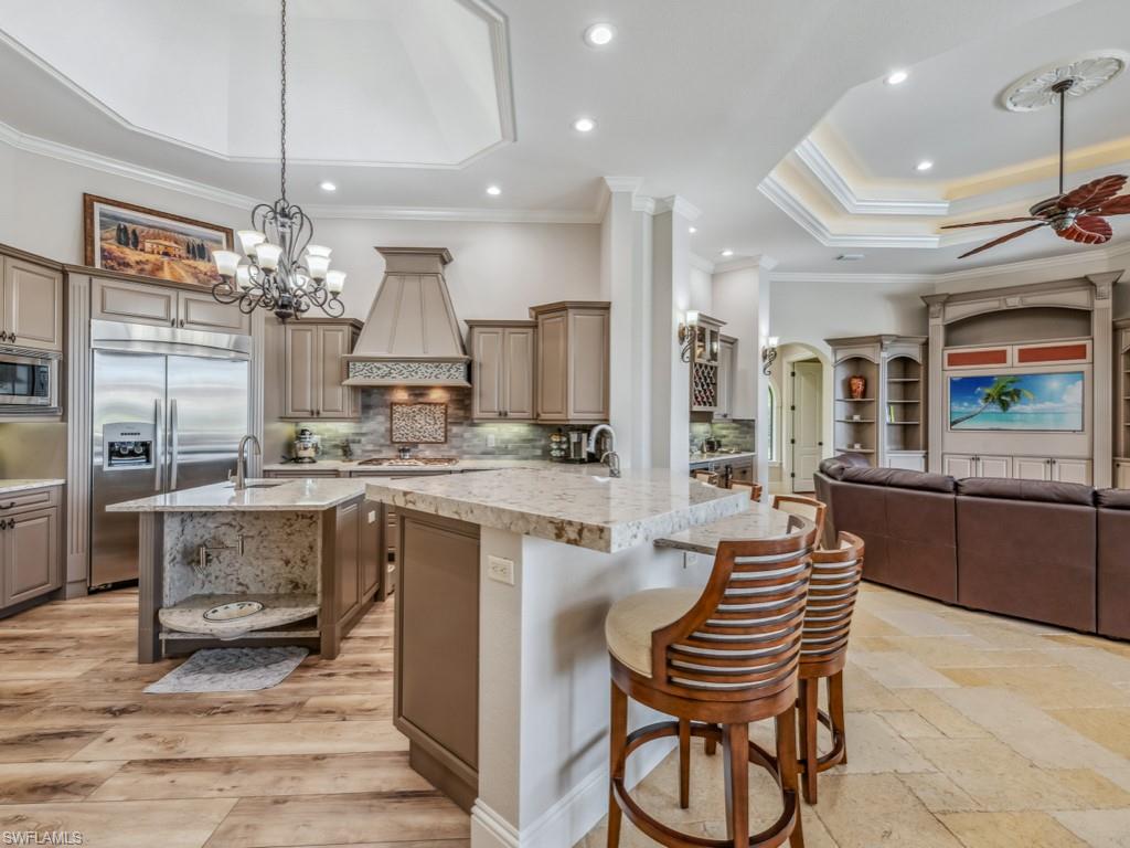 16509 Cellini Lane Naples, FL 34110 - Photo 9 of 49 a large kitchen with a table and chairs
