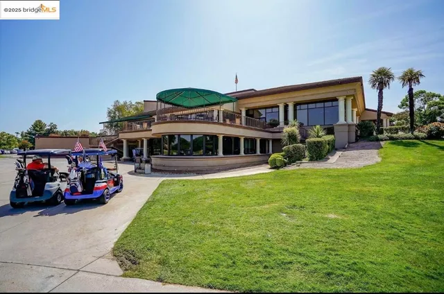 a view of a house with backyard porch and sitting area