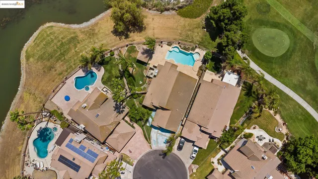 an aerial view of a swimming pool with outdoor space