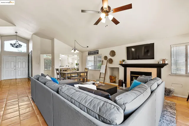 a living room with furniture fireplace and flat screen tv