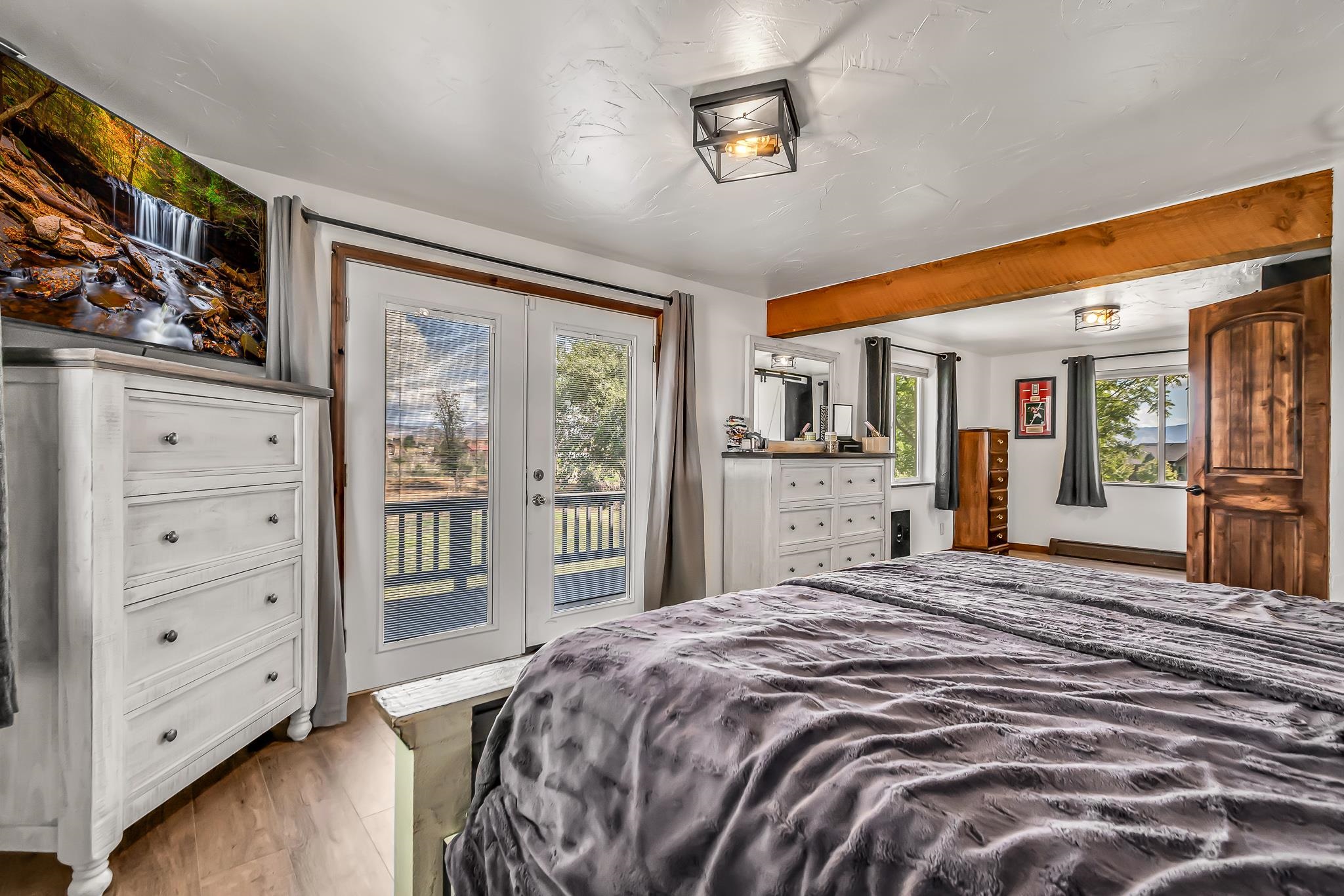 1574 P Road Loma, CO 81524 - Photo 19 of 34 a bedroom with a large bed and a dresser