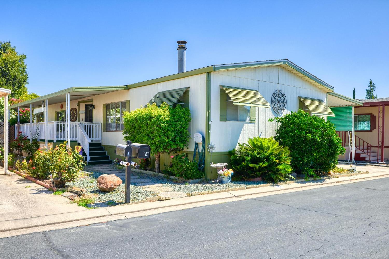 1200 South Carpenter Road, Unit 4 Modesto, CA 95351 - Photo 3 of 22 a front view of a house with garden