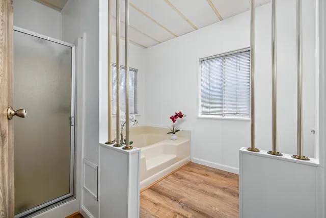 a bathroom with a tub and shower