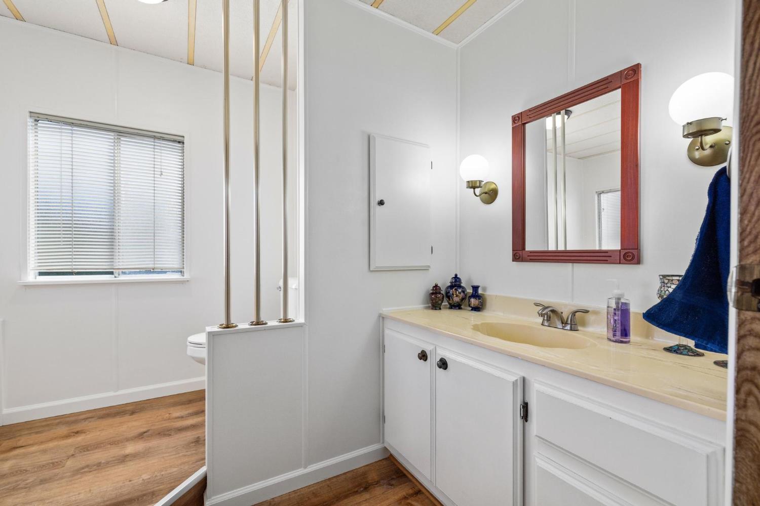 1200 South Carpenter Road, Unit 4 Modesto, CA 95351 - Photo 8 of 22 a bathroom with a sink and a mirror