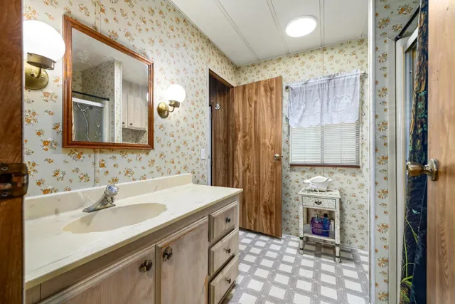 a bathroom with a sink double vanity and a mirror
