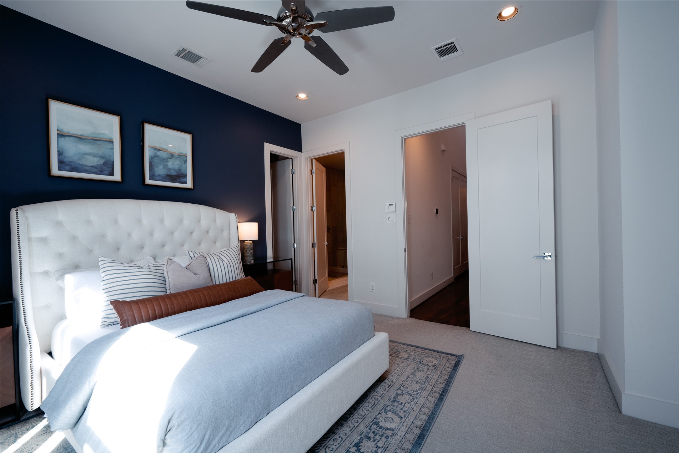 2826 Clay Street Houston, TX 77003 - Photo 15 of 22 a bedroom with a large bed and a chandelier