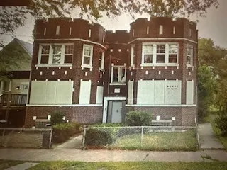 front view of a brick house with a yard