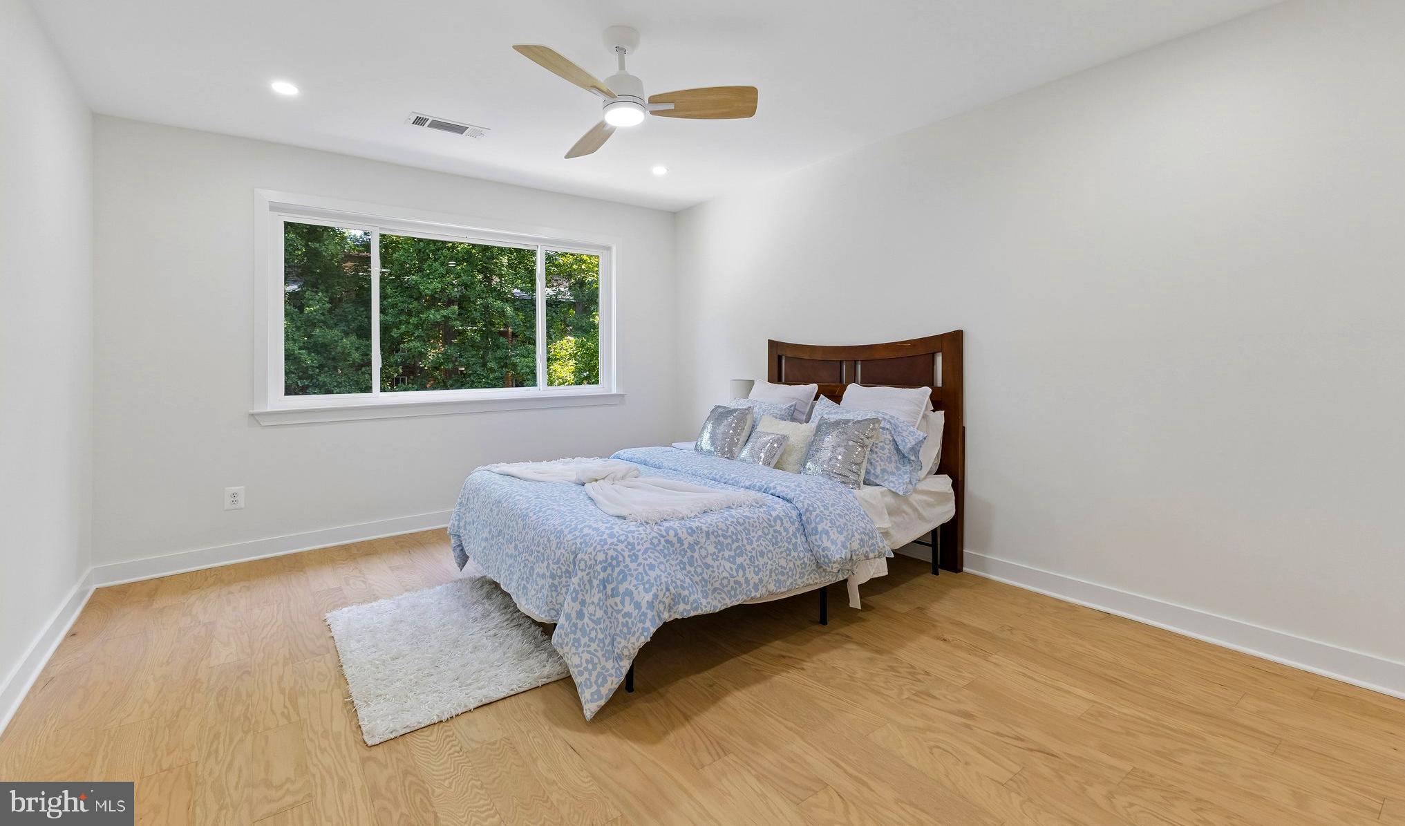 11841 Shire Court, Unit 31D Reston, VA 20191 - Photo 19 of 24 a bedroom with a bed and wooden floor